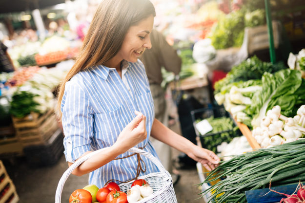 a woman shops for groceries as part of a life skills training program