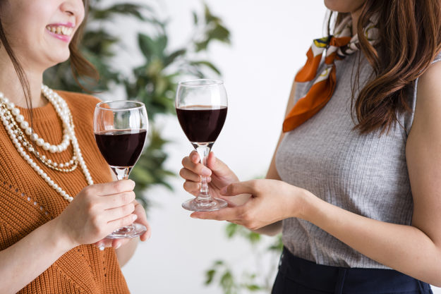 two mothers drink together as part of wine mom culture