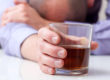 man with head down showing signs of alcoholism