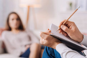 a doctor takes notes about the northern california drug and alcohol detox programs