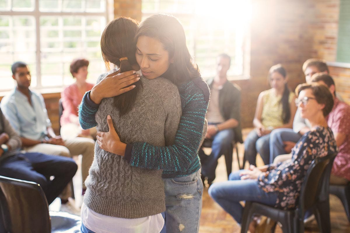 two people hug in a residential treatment program