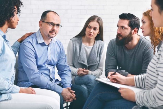 A therapist guiding a one-on-one addiction counseling session at Summit Estate in Saratoga, CA